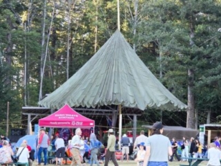 A photo of the zero-waste tent with the main stage in the background