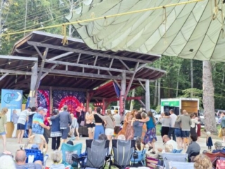 A photo of festival-goers enjoying a performance