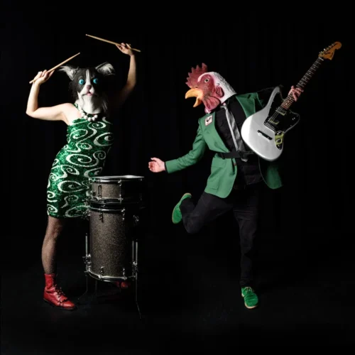 Promo photo of the duo Kitty & The Rooster with their instruments, wearing masks.