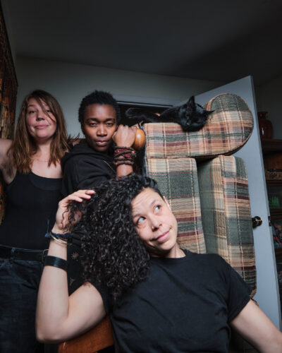 Oh Pray Tell members posing in a band photo.